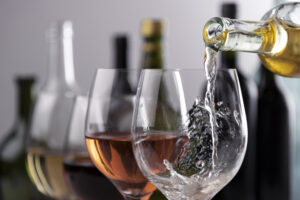 different colors of wine being poured into glasses