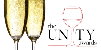 unity awards logo on white background with two glasses of sparkling white wine