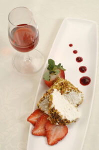 Farmer’s Cheese with Strawberries on plate with glass of red wine