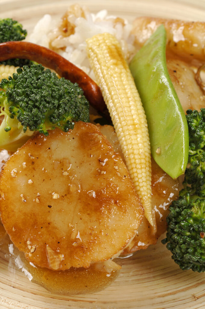close-up image of sea scallops stir fry with rice